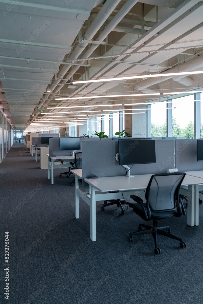 Interior of modern empty office building.Open ceiling design.Equipped with automatic lifting table and LCD screen. Interior of modern empty office building.Open ceiling design.Equipped with automatic lifting table and LCD screen.