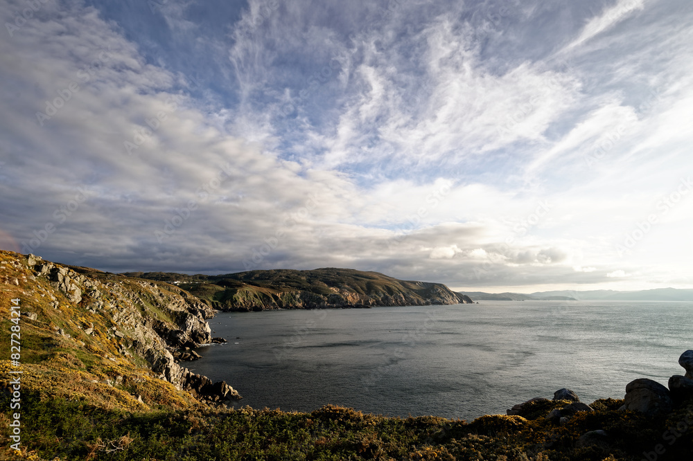 large body of water near shore covered with hills and rocks large body of water near shore covered with hills and rocks