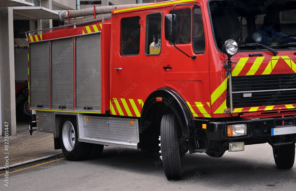 Firefighter vehicle leaving the fire station on an urgent rescue mission