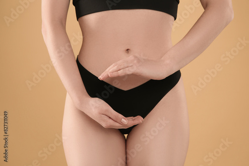 Gynecology. Woman in underwear on yellow background, closeup