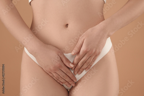 Gynecology. Woman in underwear on beige background  closeup