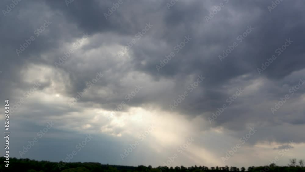 Gloomy clouds and beams of light piercing through the sky before a storm. Time lapse. Gloomy clouds and beams of light piercing through the sky before a storm. Time lapse.