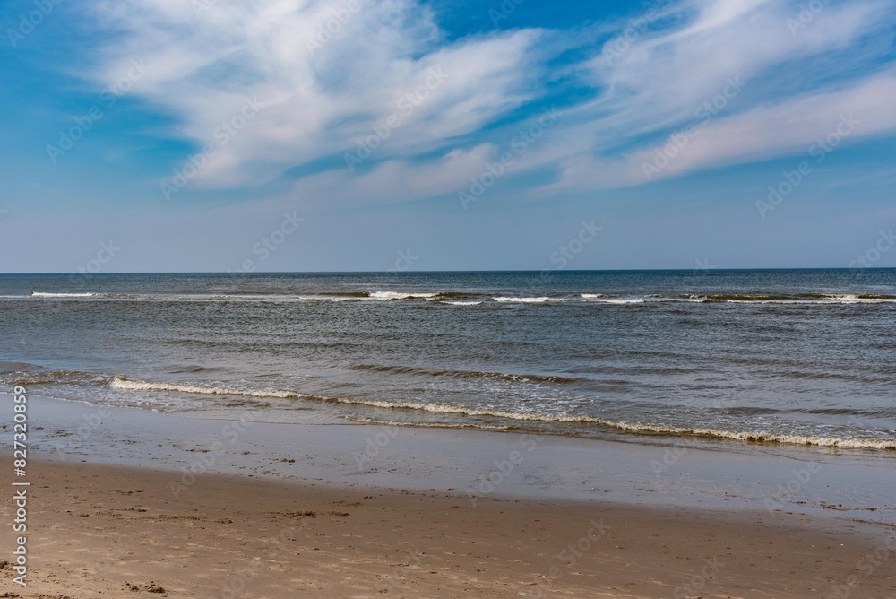 Callantsoog Netherlands Northsea coast with blue sky and little waves Callantsoog Netherlands Northsea coast with blue sky and little waves