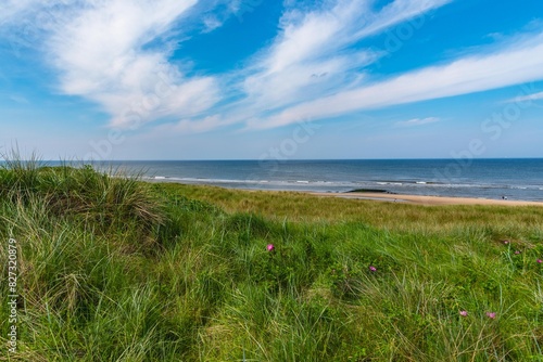 Callantsoog Netherlands Northsea coast with blue sky and little waves