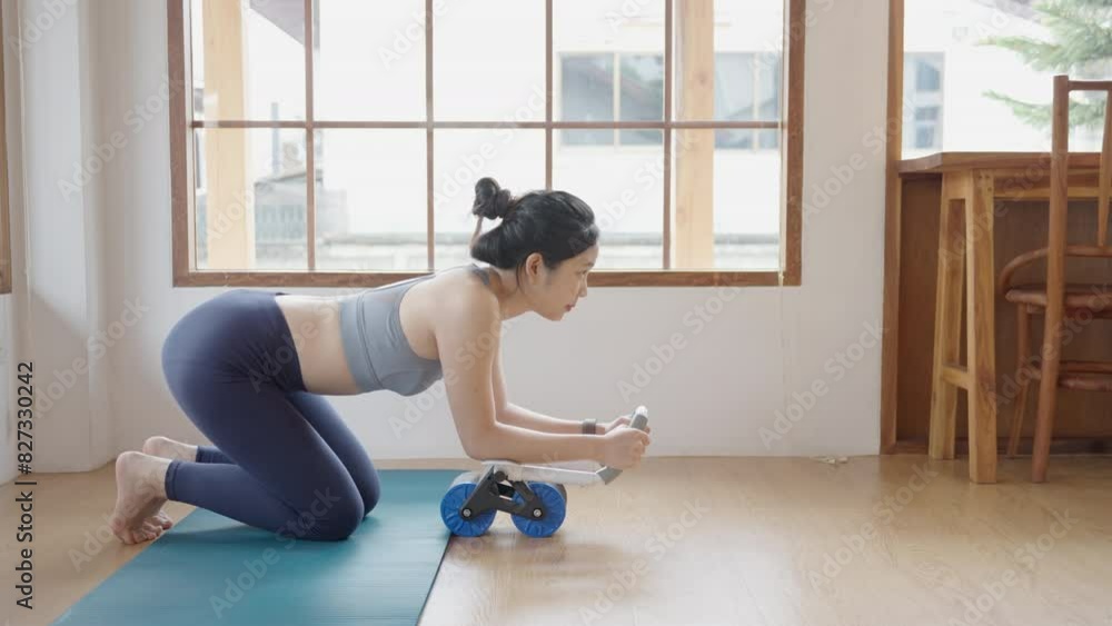 Asian young woman in workout at her home exercise routine Asian young woman in workout at her home exercise routine