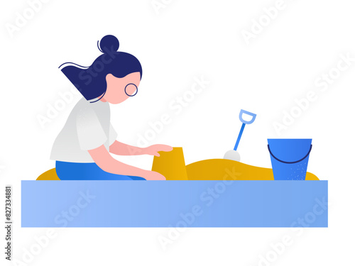 Girl plays in the sandbox and makes a sand cake