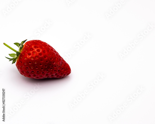 a half eaten red strawberry against a white background photo via getty for digitale photo