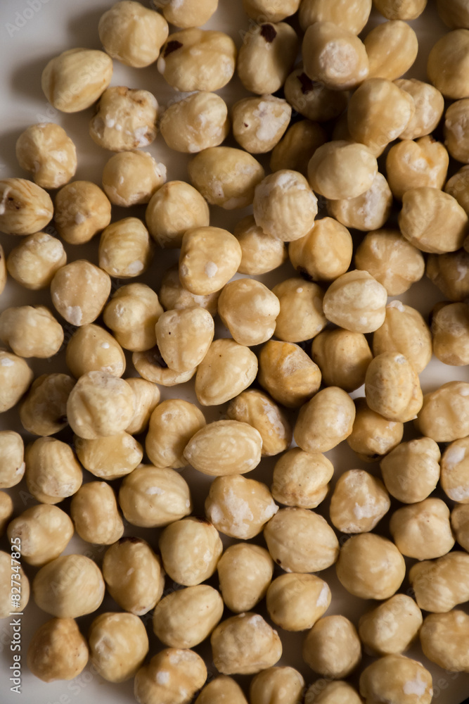 Plate of assorted nuts on a white counter Plate of assorted nuts on a white counter
