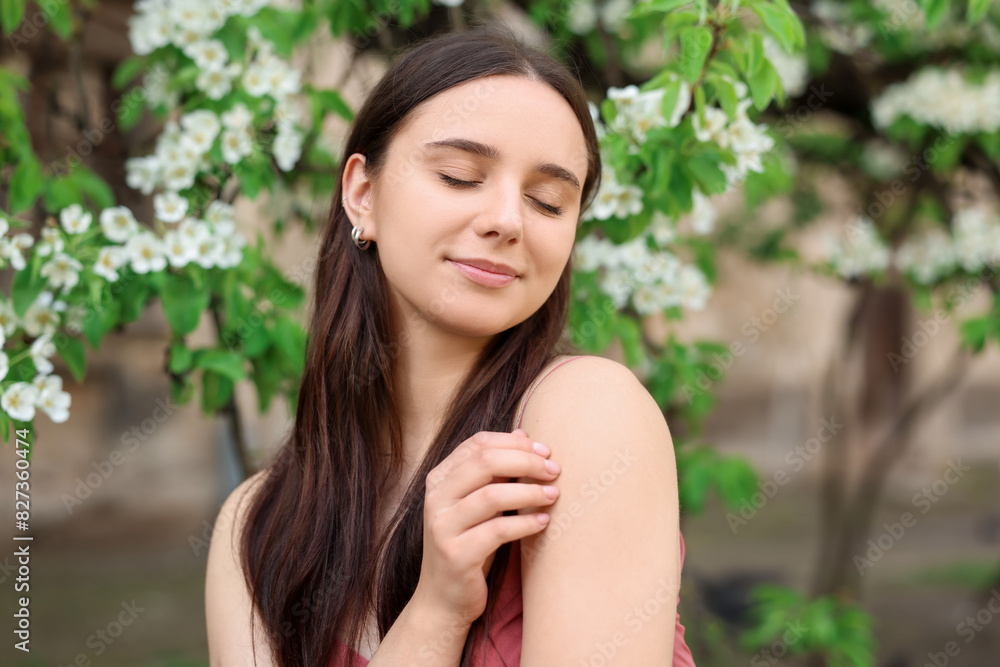 Beautiful woman near blossoming tree on spring day Beautiful woman near blossoming tree on spring day