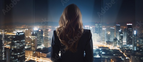 businesswoman looking at night city