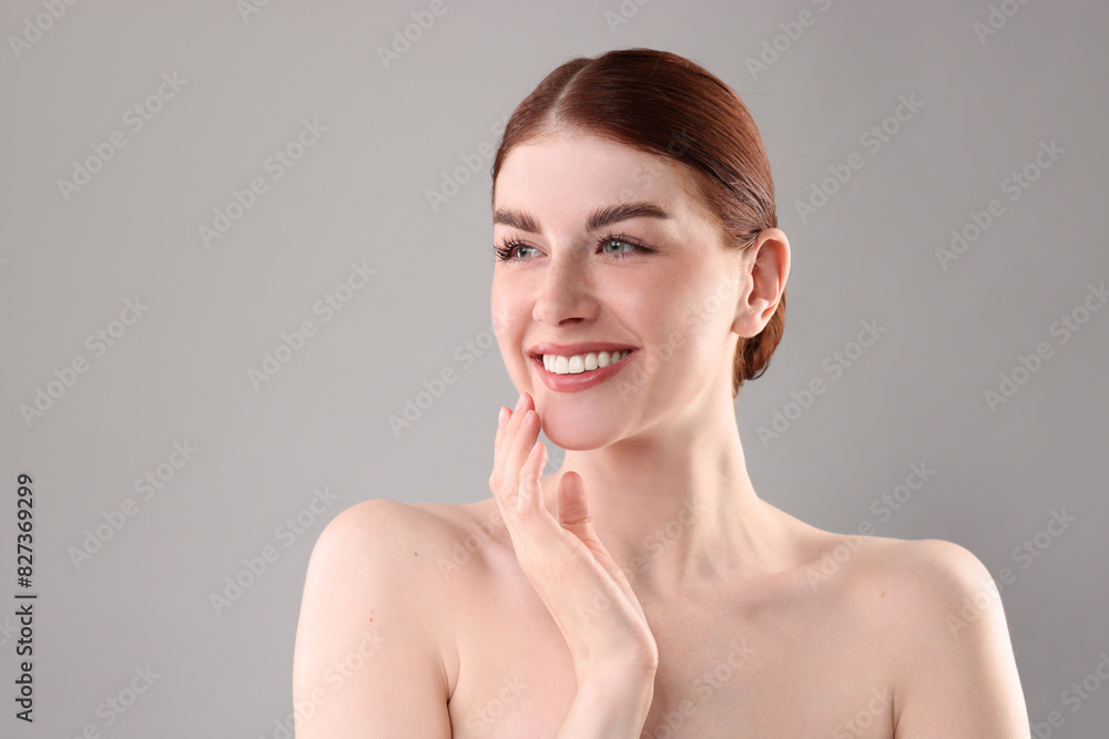 Portrait of smiling woman on grey background Portrait of smiling woman on grey background