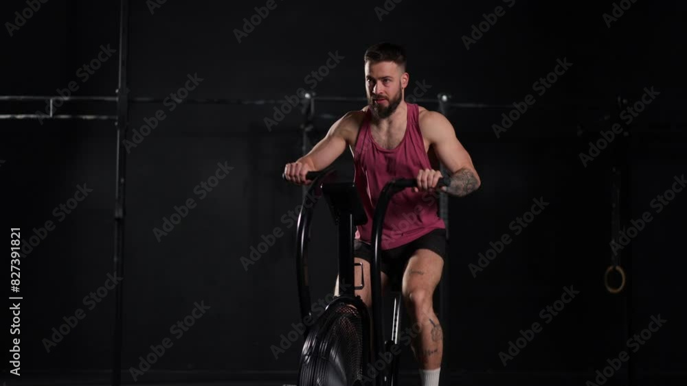 Man exercising on elliptical cross-trainer machine, wearing activewear. Routine workout for physical and mental health. Man exercising on elliptical cross-trainer machine, wearing activewear. Routine workout for physical and mental health.