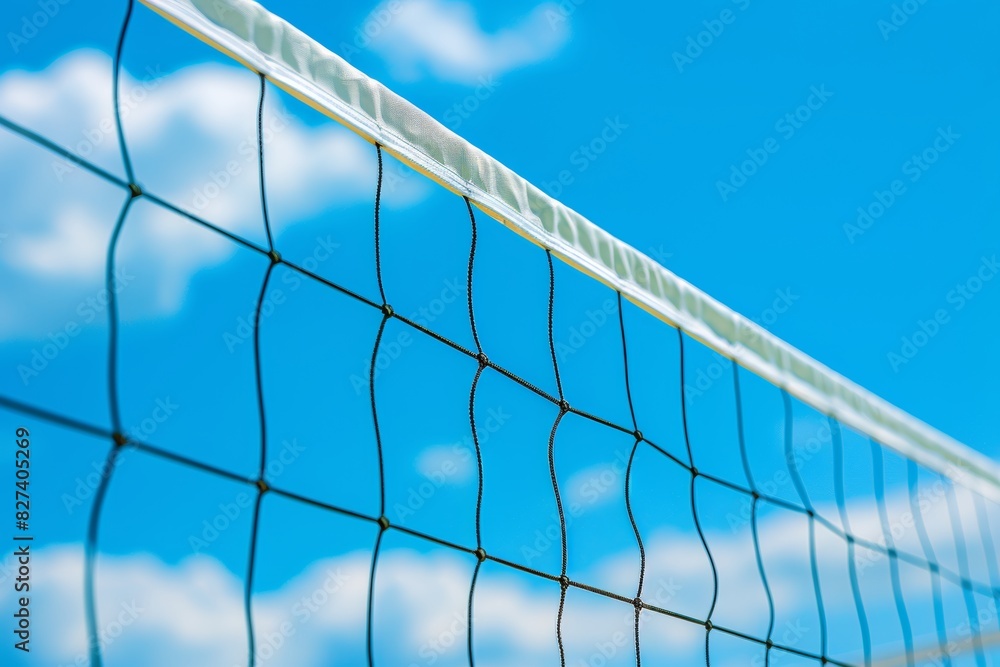 Vibrant beach volleyball net against blue sky summer olympic games sport concept Vibrant beach volleyball net against blue sky summer olympic games sport concept