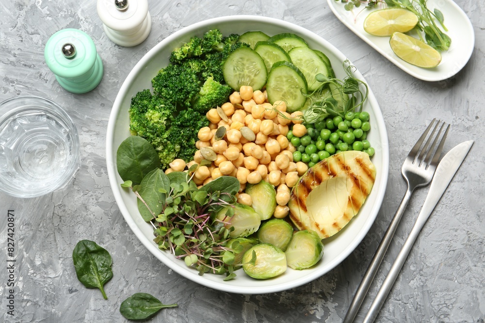 Healthy meal. Tasty vegetables and chickpeas in bowl on grey table, flat lay Healthy meal. Tasty vegetables and chickpeas in bowl on grey table, flat lay