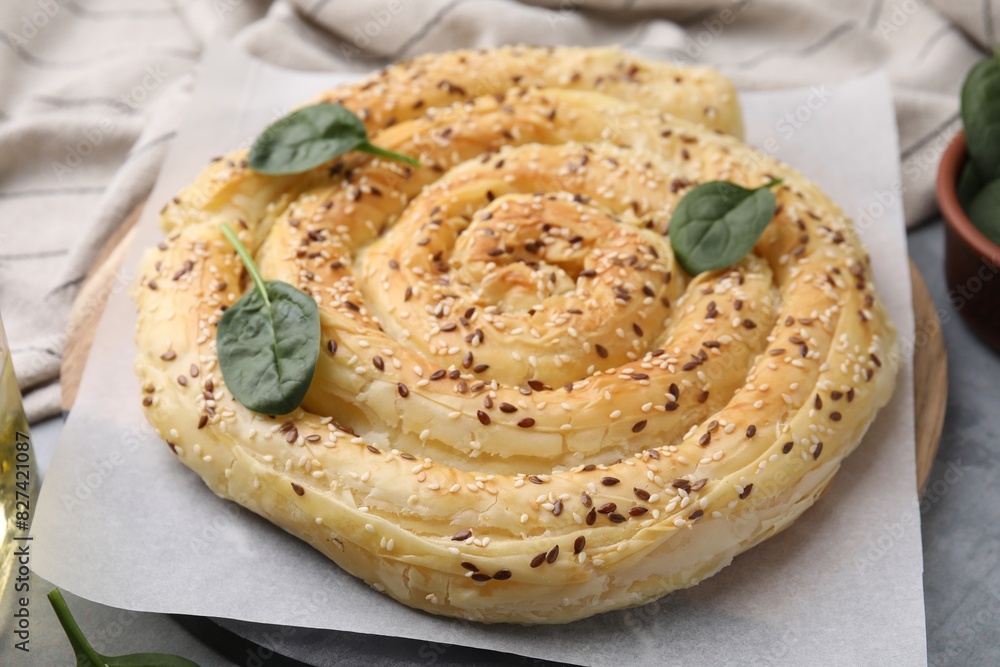 Delicious puff pastry with spinach on grey table, closeup Delicious puff pastry with spinach on grey table, closeup
