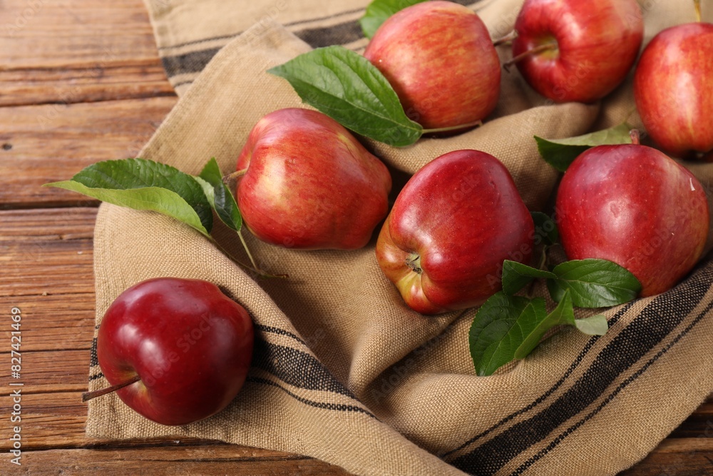 Ripe red apples with leaves on wooden table Ripe red apples with leaves on wooden table