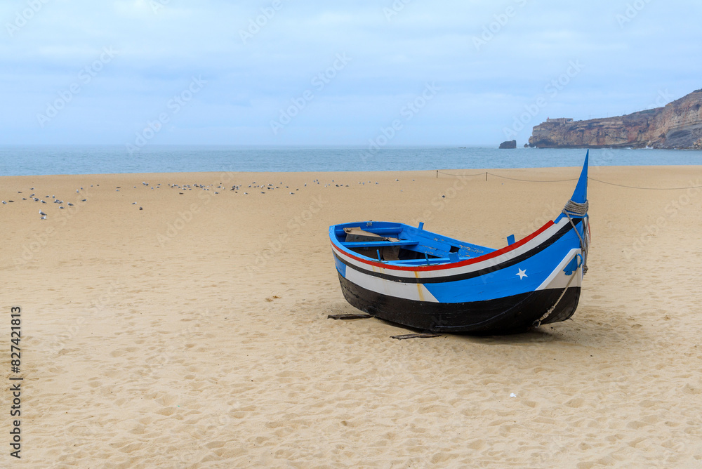 colorful fishing boat made of wood on the beach village Nazare, Portugal colorful fishing boat made of wood on the beach village Nazare, Portugal