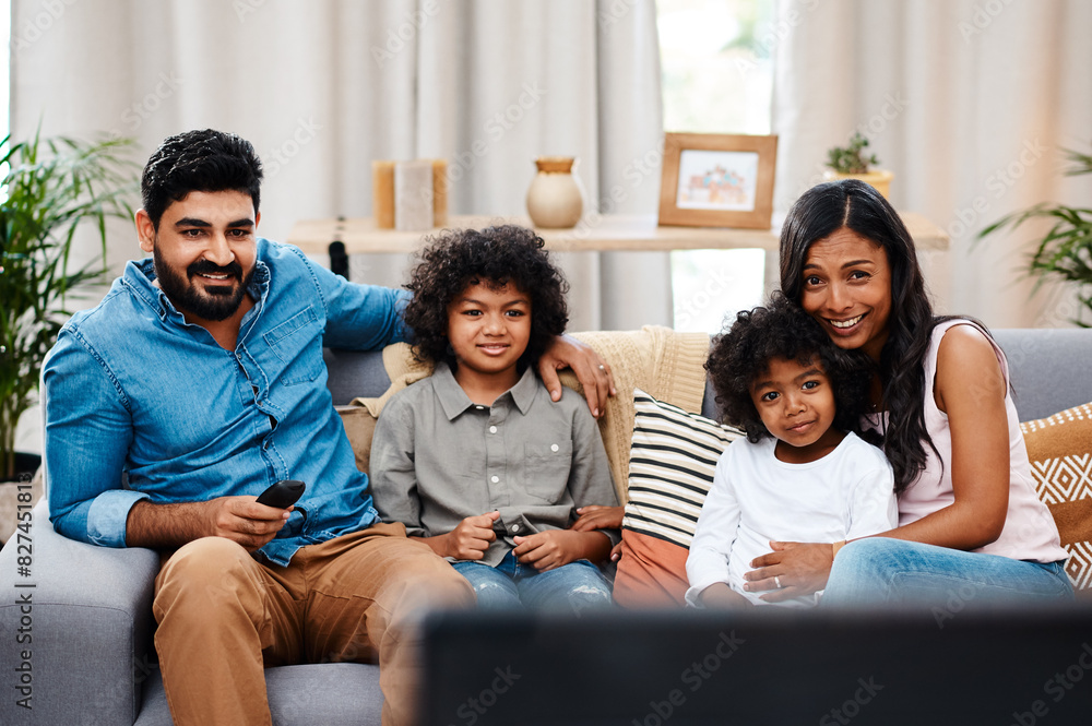 Dad, mom and children in living room watching tv on sofa with family, bonding together and smile. Weekend, relax and kids on couch streaming movie or television show with subscription in Spain. Dad, mom and children in living room watching tv on sofa with family, bonding together and smile. Weekend, relax and kids on couch streaming movie or television show with subscription in Spain.