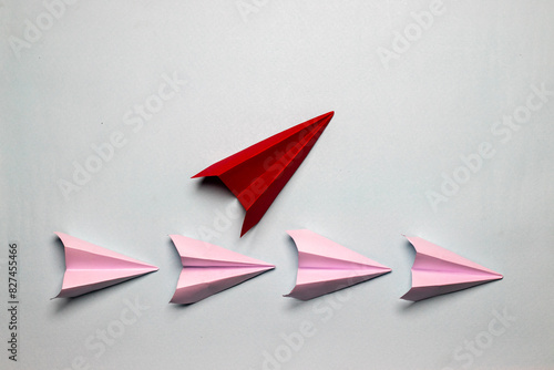 Business concept red plane with white paper planes on a light grey background motivation aviation concept

