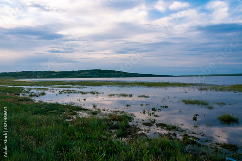 Summer landscape  reflection of clouds on shallow water in flat water Tiligul estuary  Ukraine