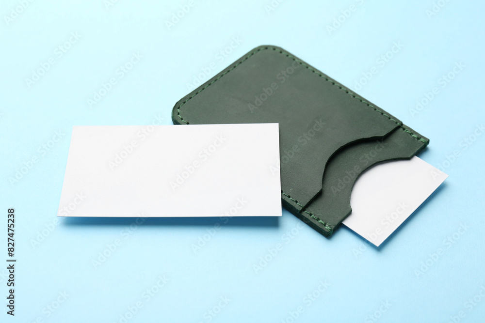 Leather business card holder with blank cards on light blue background Leather business card holder with blank cards on light blue background
