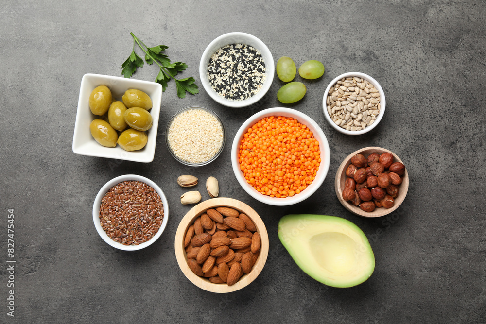 Different products high in natural fats on grey table, flat lay