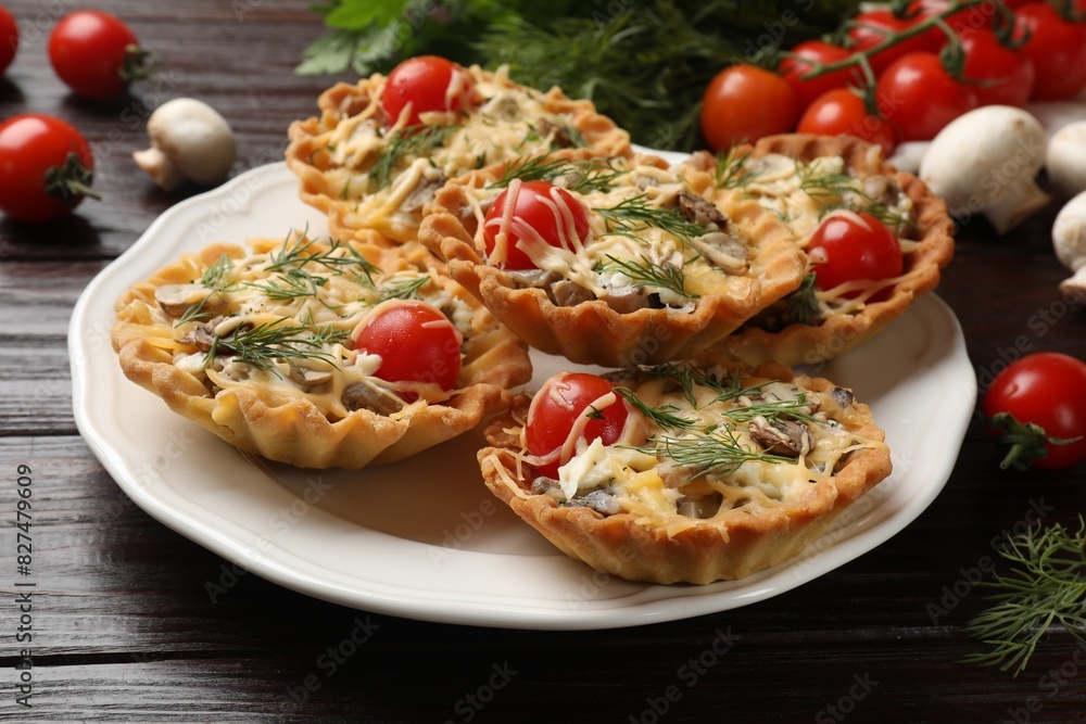 Fototapeta premium Tasty tartlets with cheese, tomatoes, mushrooms and dill on wooden table, closeup