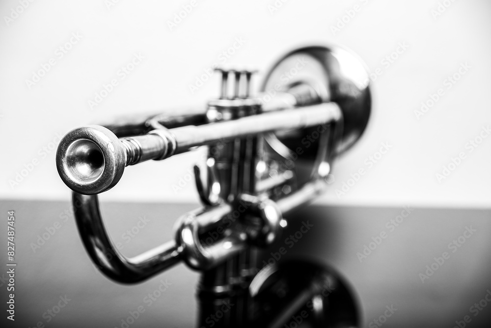Classical trumpet on black glass table with white background; perfect shot for music lovers capturing the elegance of a brass instrument used in symphonies and concerts, ideal for classical music them Classical trumpet on black glass table with white background; perfect shot for music lovers capturing the elegance of a brass instrument used in symphonies and concerts, ideal for classical music them