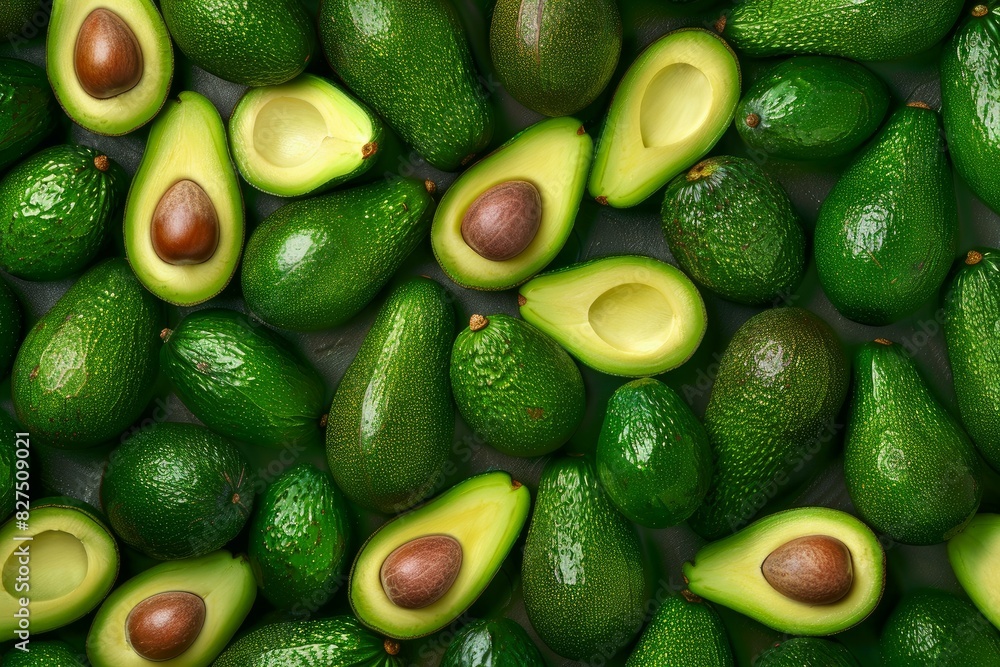 Top view of whole and halved avocados neatly arranged, showcasing their vibrant green flesh Top view of whole and halved avocados neatly arranged, showcasing their vibrant green flesh