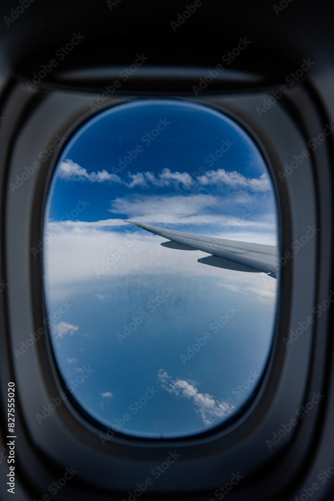 View from an airplane window, showcasing the wing against a backdrop of a vast, cloud-filled sky. Scene conveys sense of height and tranquility, with the horizon blending into soft blue gradient. View from an airplane window, showcasing the wing against a backdrop of a vast, cloud-filled sky. Scene conveys sense of height and tranquility, with the horizon blending into soft blue gradient.