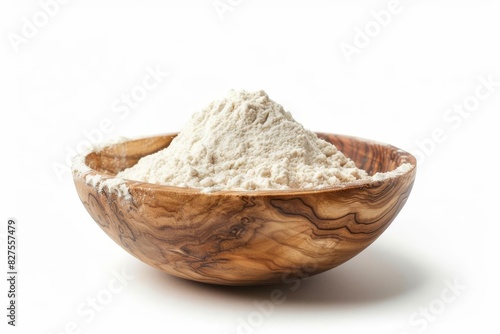 heap of white wheat flour in rustic wooden bowl isolated on pure white background food ingredient photo