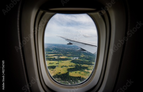 the serene beauty from an airplane window, featuring the wing silhouetted against an expansive, cloud-filled sky, instilling a sense of height and peacefulness.