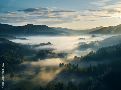 Dawn unveils a mystical scene with fog over forests and mountains