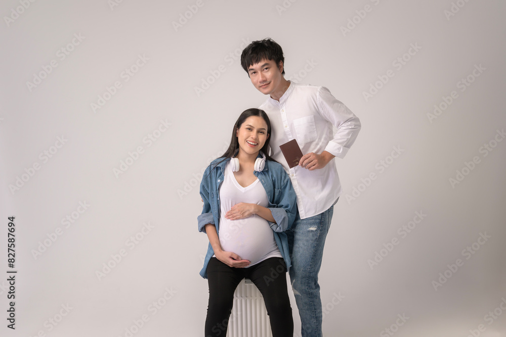 Portrait of Beautiful pregnant woman and husband traveling over white background studio, insurance and maternity concept Portrait of Beautiful pregnant woman and husband traveling over white background studio, insurance and maternity concept