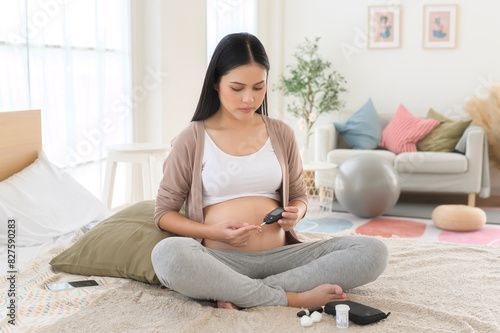 Canvastavla Pregnant woman checking blood sugar level by using Digital Glucose meter, health