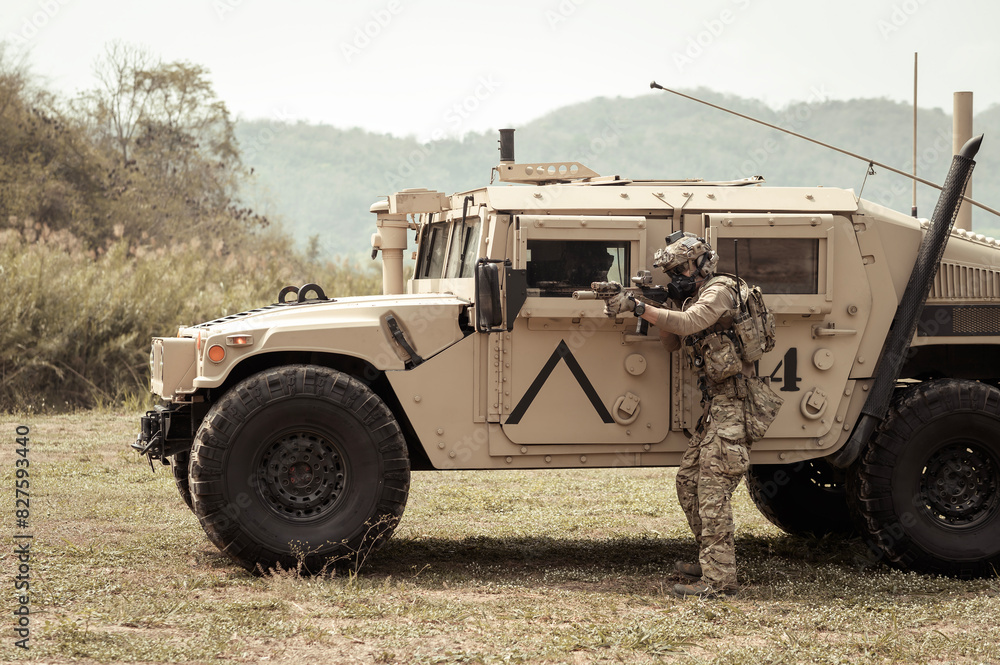 United States Army in camouflage uniforms operation in the forest.with armored vehicle, soldiers training in a military operation United States Army in camouflage uniforms operation in the forest.with armored vehicle, soldiers training in a military operation