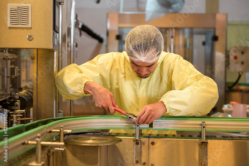 Professional winemaker controlling wine making process and quality at winery factory