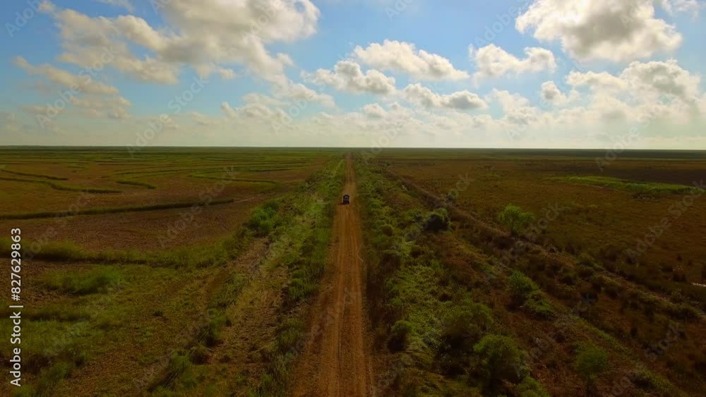 Aerial Scenic Shot Of Pick-Up Truck Moving On Dirt Road, Drone Flying Forward In Field During Sunny Day - Bayou Vista, Texas Aerial Scenic Shot Of Pick-Up Truck Moving On Dirt Road, Drone Flying Forward In Field During Sunny Day - Bayou Vista, Texas