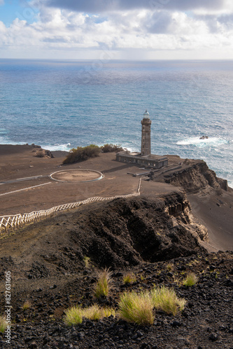 Farol da Ponta dos Capelinhos lighthouse at Faial island of the Azores, Portugal. Former beacon on the Atlantic Ocean coast. Eruption of Capelinhos volcano.