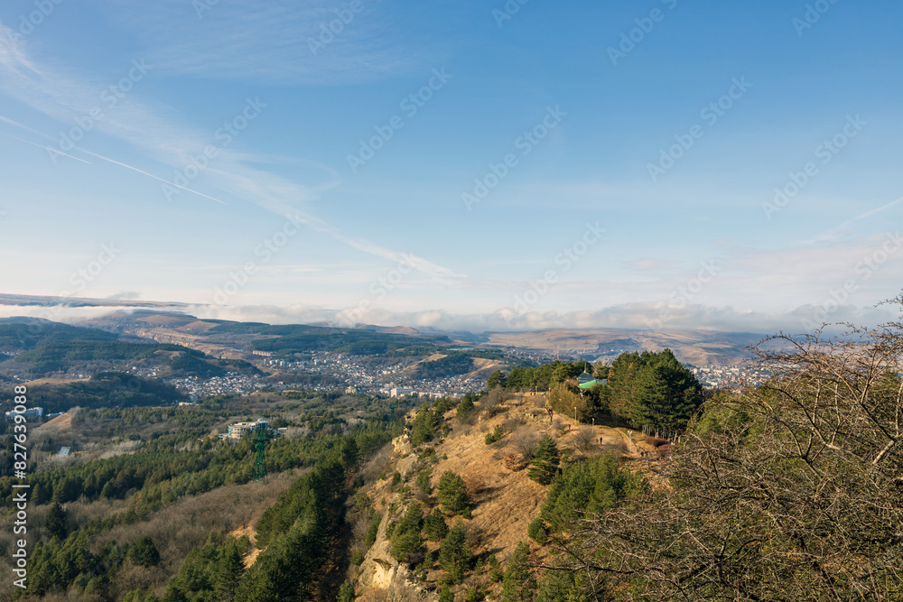 Naklejka premium A beautiful landscaped park with benches, paths and green lawns, a gazebo in the morning in the fog.