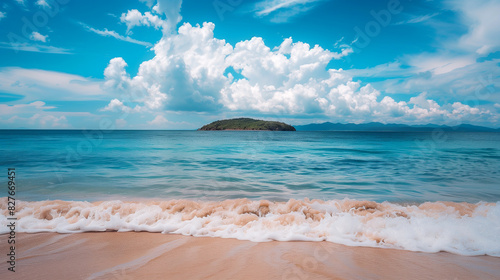 Beach landscape with island on horizon. Empty tropical beach and seascape. Blue sky  soft sand  calmness and relaxing. Summer vacation.