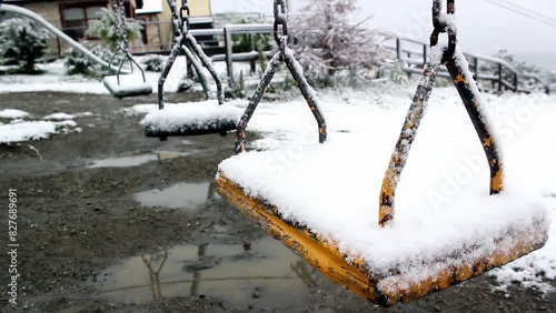 Snow-covered Swings in a Public Park in Ushuaia, Tierra del Fuego Province, Argentina. Close Up. 4K Resolution. photo