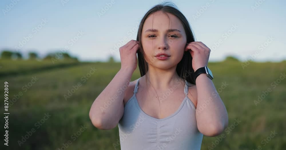 Sporty woman wearing earphones at the nature, slow motion Sporty woman wearing earphones at the nature, slow motion
