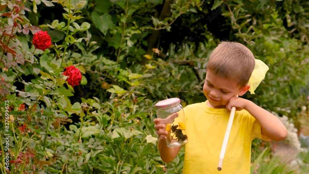 child plays with a butterfly in the garden. Selective focus. child plays with a butterfly in the garden. Selective focus.