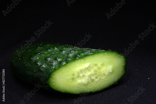 A juicy cut cucumber on a dark background