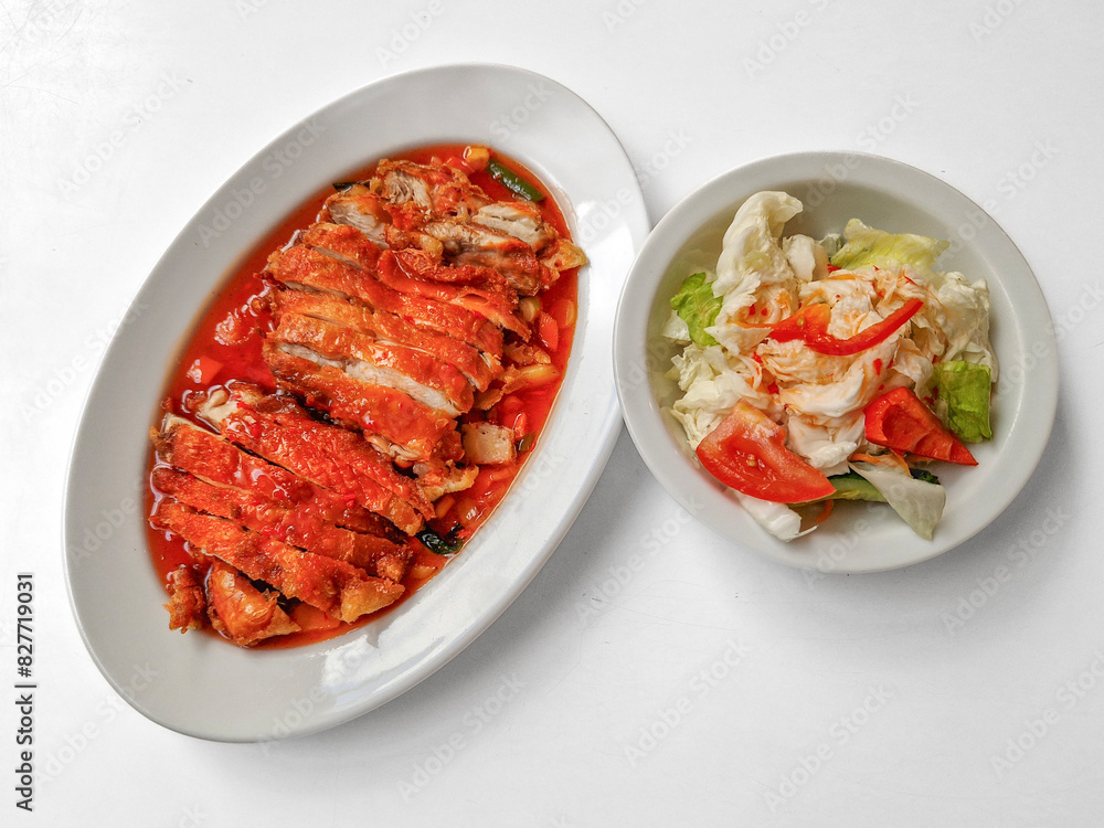 Chicken baked with onion in tomatoes with white cabbage salad. Chicken baked with onion in tomatoes with white cabbage salad.