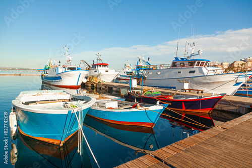 Fishing ships and boats moored at the pier. photo