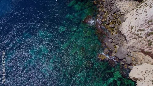 Aerial sea view. emerald and blue water with purple algae on the rocky coasr. Sea water backgound. Malta, blue Grotto coast. High quality 4k footage photo