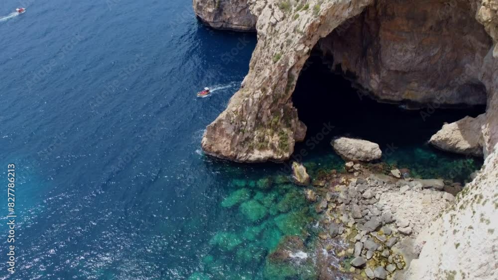 Malta, Blue Grotto, Aerial view of famous beautiful rocks in the meditteranean sea, Maltese island caves. Boat tours , birds. Shot reveals emerald water and rocky coast. High quality 4k footage Malta, Blue Grotto, Aerial view of famous beautiful rocks in the meditteranean sea, Maltese island caves. Boat tours , birds. Shot reveals emerald water and rocky coast. High quality 4k footage