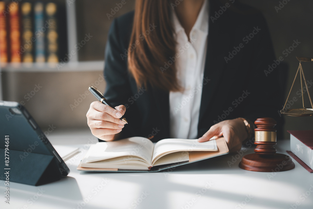 Thoughtful businesswoman is in a legal office with a gavel on her desk. She looks pensive and focused, indicating a deep involvement in her legal work and responsibilities. Thoughtful businesswoman is in a legal office with a gavel on her desk. She looks pensive and focused, indicating a deep involvement in her legal work and responsibilities.